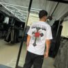 POLERA REBELLION CRUZ CON BRILLO ROSA WHITE OVERSIZE