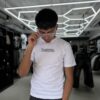 POLERA RESTRICTED BLANCA SLIM FIT NIÑO BRILLO